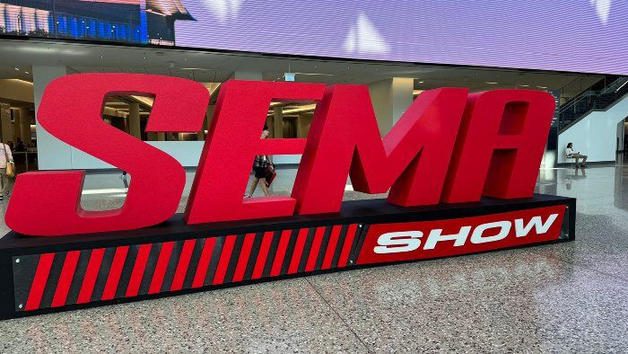 A prominent sign reading "SEMA Show," featuring a case study from JSK Marketing